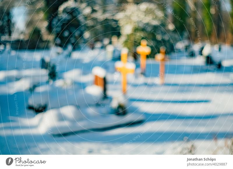 Grave in cemetery in winter with snow death and eternity Goodbye Funeral bokeh Christianity Coronatote Corona winter Eternity Cemetery Prayer commemoration