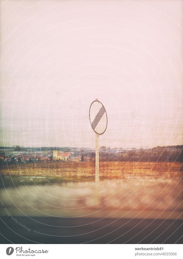 White traffic sign on a blurry landscape background with grunge effects white blurred nature rural germany europe village panorama outdoors no people concepts