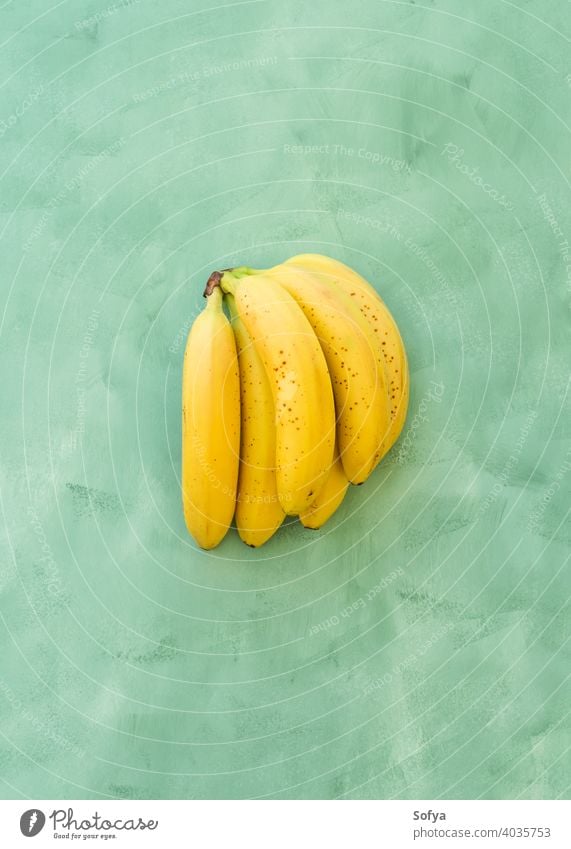 Whole bunch of bananas fruit on green yellow background ripe fresh summer organic texture close group stem sweet delicious food healthy whole exotic natural