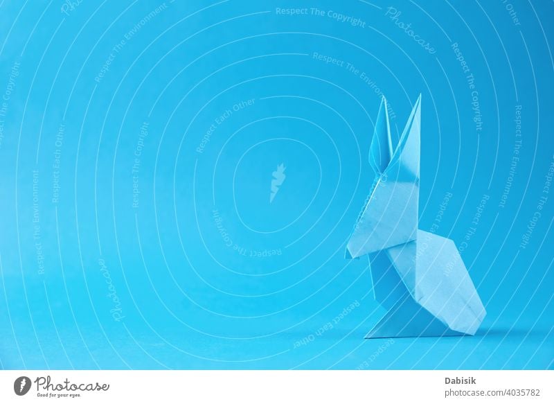 Paper origami Esater rabbit on a blue background. Easter celebration concept easter bunny holiday animal decoration spring happy paper cute art colorful