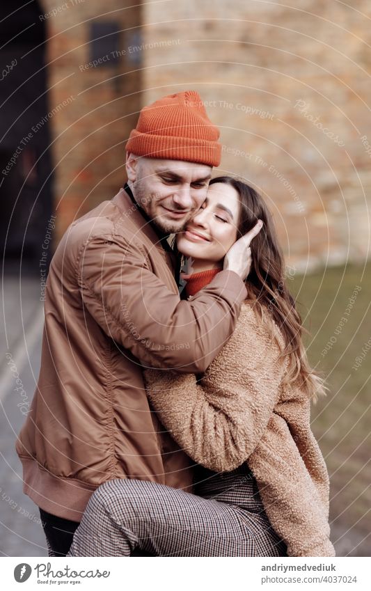 Beautiful Tourist Couple In Love Walking On Street Together. Happy Young Man And Smiling Woman Walking Around Old Town Streets, Looking At Architecture. Travel Concept.