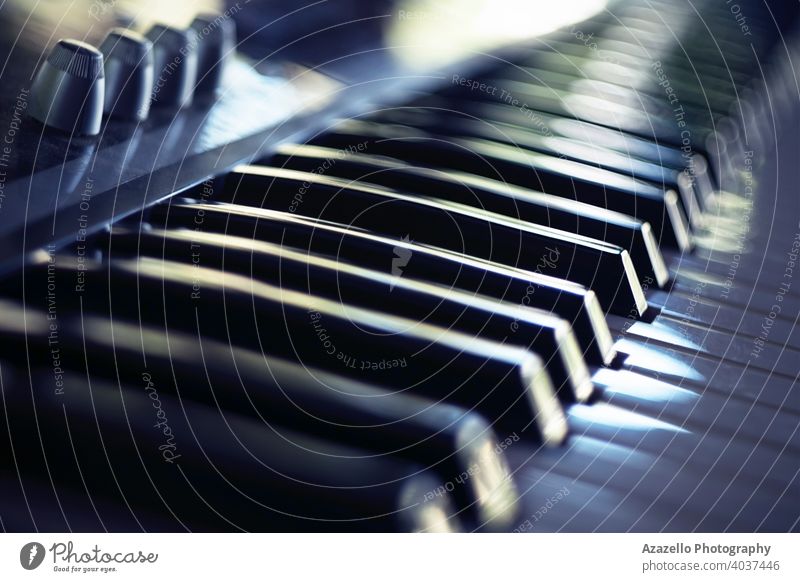 Electric piano keyboard in blur. Piano keyboard with day light reflections. acoustic audio background band black blue bokeh child chord classical close up