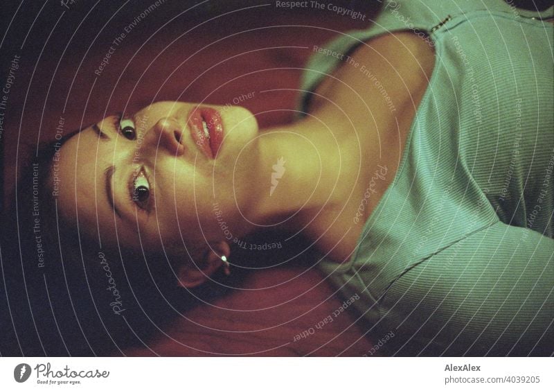 analogue portrait of a young beautiful woman lying on a wooden table teen Face Woman Identity Esthetic grain Love expectant Top Graceful Sportiness overhead