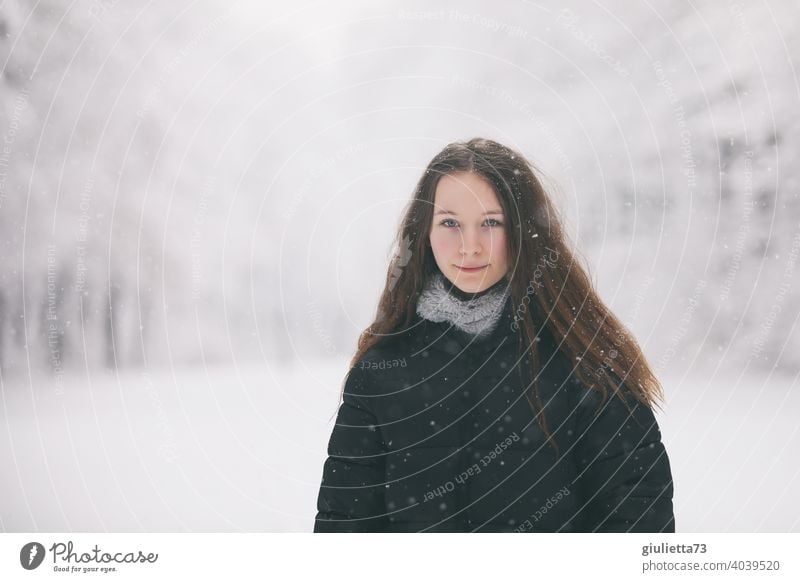 Portrait of long haired teen girl in winter snowfall White Feminine snowy Long-haired 13 - 18 years pretty naturally Looking Neutral Background