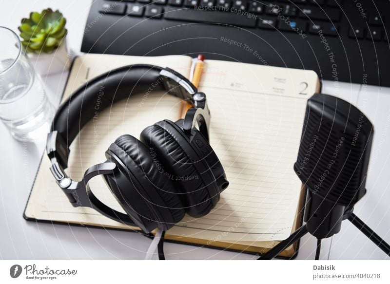 Microphone and headphones on the table, top view. Radio podcast workplace microphone audio radio online technology keyboard remote education learning e-learning