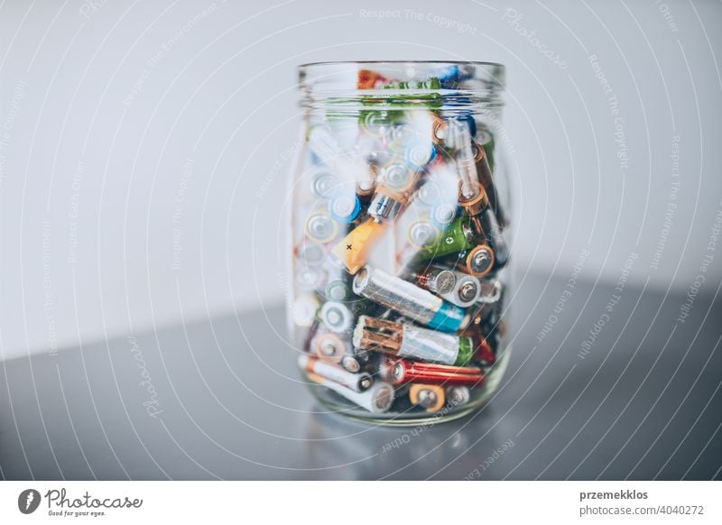Jar filled with discharged used batteries. Waste disposal and recycling. Separating the waste battery bin collecting concept conceptual dispose ecological