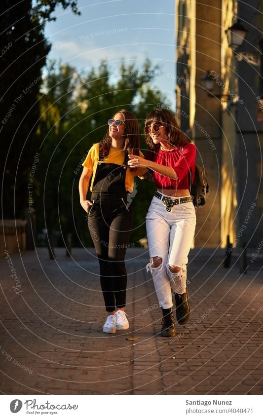 Two Teenager Girls Walking Down The Street. - A Royalty Free Stock ...