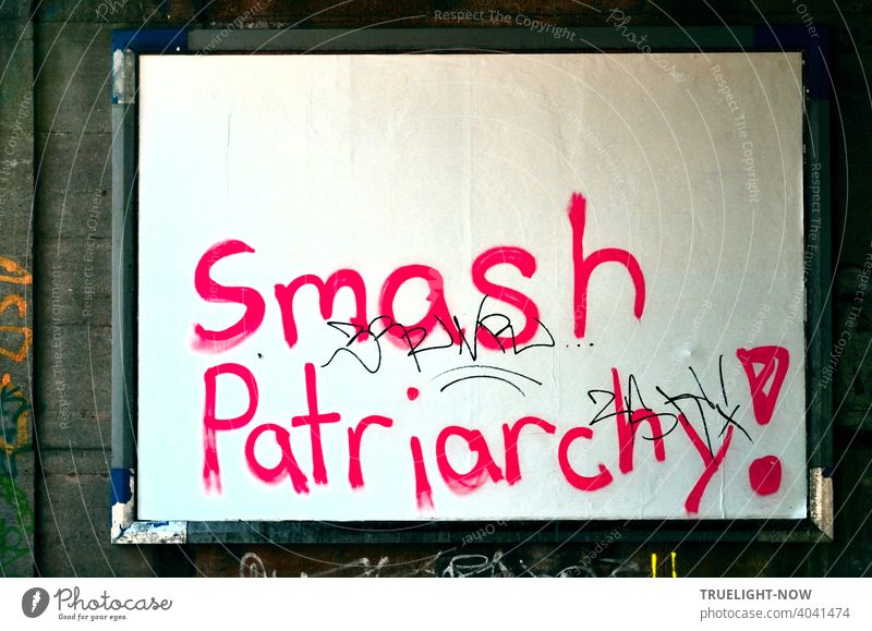 Women's Day! Excited young women in wild rage used the will-less surrender of innocent white billboard wall for blood-red angry battle slogan. Smash Patriarchy!