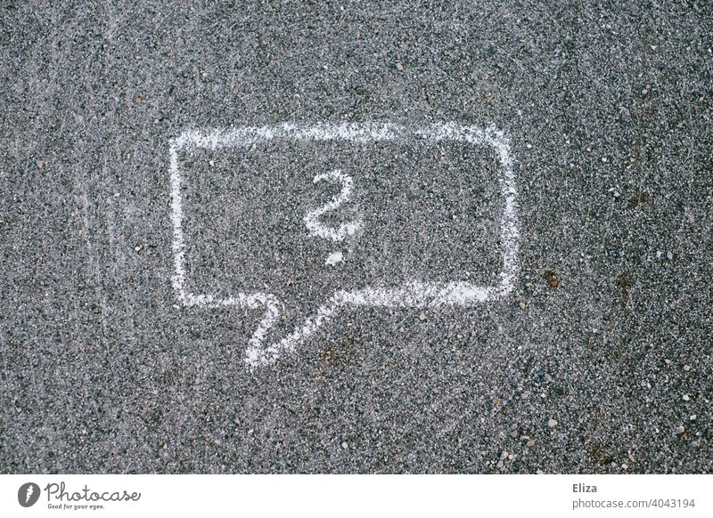 A speech bubble with question marks drawn on the road with chalk Speech bubble Question mark Perplexity asking Ignorance disorientation Chalk Insecure