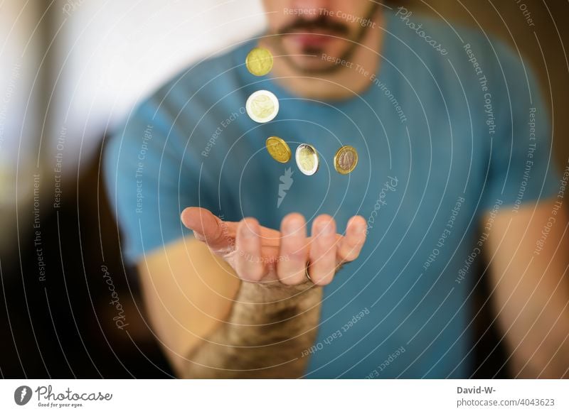 Man catches coins with his hand Money Coin € euro coins Euro Luxury Success finance Thrifty capital austere creatively Avaricious Loose change investment assets