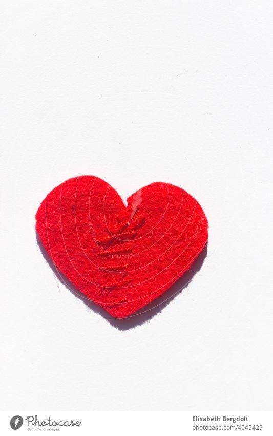 sewn together red heart (made of felt) on white background Lovesickness heartache Heart Divorce Hope Divide pain of separation repair Pain