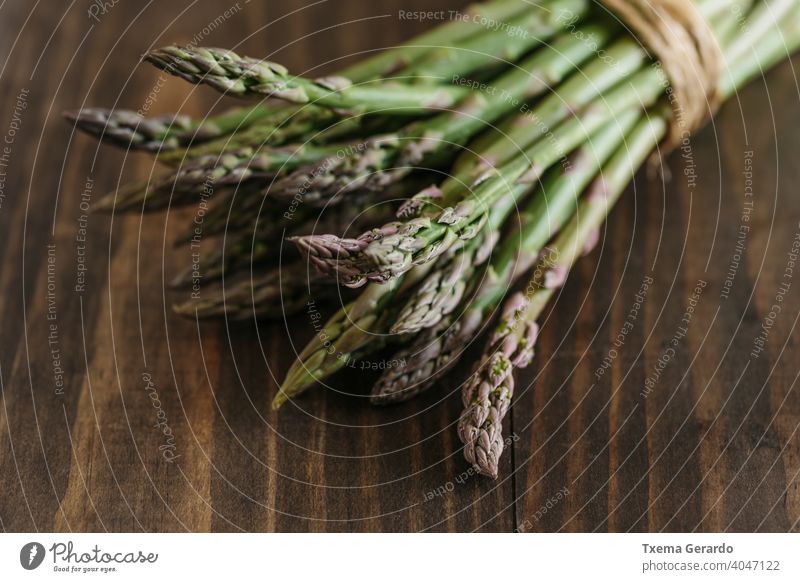 Bunch of raw fresh asparagus on wooden table. Focus on foreground. food green vegetable healthy background diet pepper eating nutrition meal organic fruit