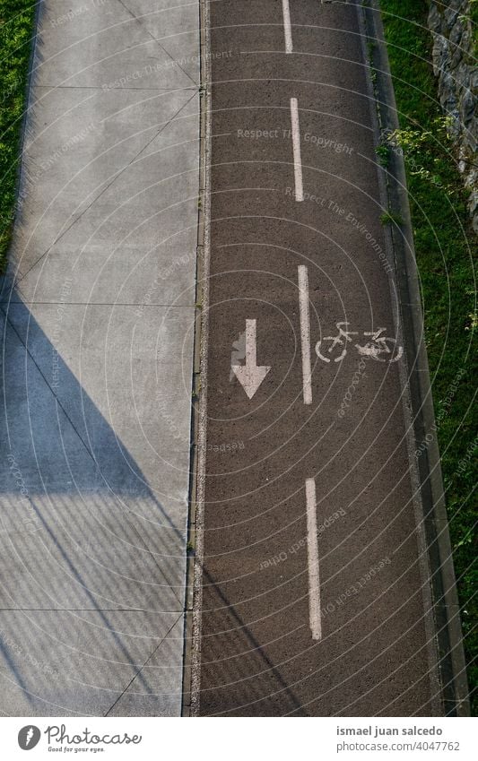empty cycling track on the street cycle cycle track bicycle track road road sign traffic signal symbol arrow way path sport asphalt outdoors safety roadsign