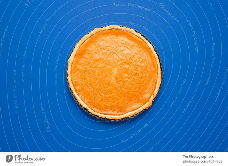 Pumpkin pie top view minimalist on a blue background. 4 july above view american food autumn baked bakery baking cake christmas comfort food context cooking