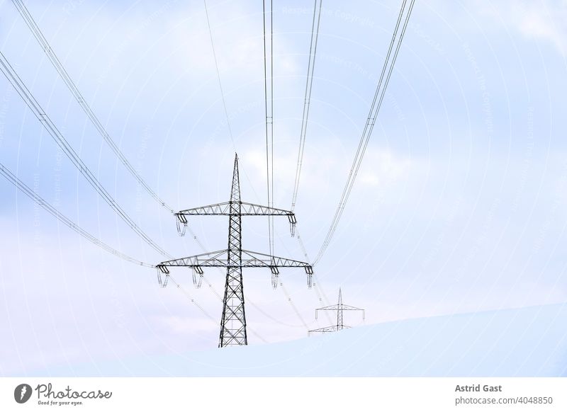 Overhead line pylons in Germany in winter in the snow Electricity pylon Overhead line mast Pole Cable stream power cable power line Power generation Electrics
