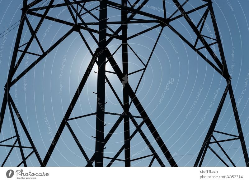 overhead line high voltage power pole lattice tower in front of blue sky Electricity pylon stream High voltage power line high-voltage cables