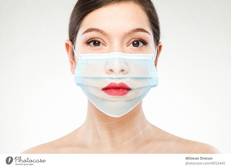Beautiful caucasian young woman headshot wearing transparent medical face mask covid-19 coronavirus portrait fashion art concept edit adult attractive