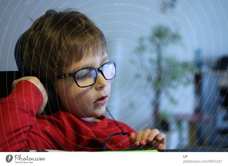 child wearing glasses and listening to headphones safety epidemic quarantine music family time Listening Listen to music Technology Questioning Relaxation