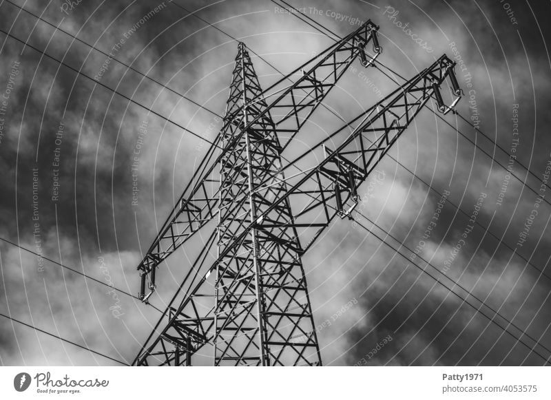 Electric pylon in front of dramatic cloudy sky b/w photo Electricity pylon Energy industry Sky Cable Industry High voltage power line Technology