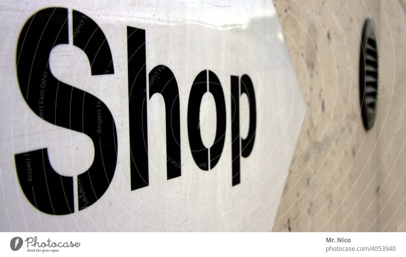 shop Signs and labeling Work and employment Characters Shopping publicity Typography Trade booths Signage Letters (alphabet) Wall (building) Gray Arrow Facade