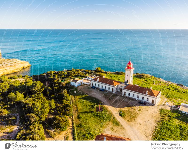 Cliffy coast with Alfazinha Lighthouse in Carvoeiro, Algarve, Portugal algarve lighthouse carvoeiro portugal portimao outdoor historic south copy scape red