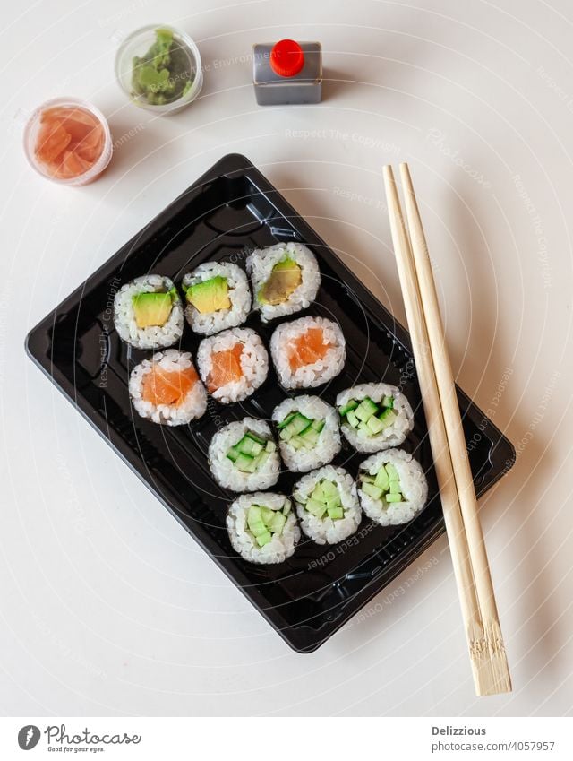 Top down view of fresh take away sushi on a white background with copy space sushis chop sticks food ginger wasabi japanese japanese food pickled ginger
