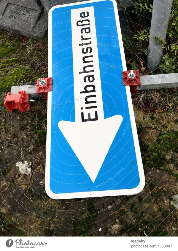 Overturned temporary traffic sign at a one-way street at a construction site in Oerlinghausen near Bielefeld at the Hermannsweg in the Teutoburg Forest in East Westphalia-Lippe