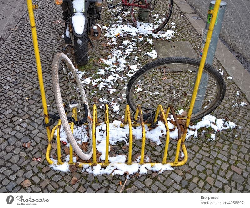 Two connected front wheels of bicycles, the rest of the bicycles have been obviously stolen Front wheel Associated Bicycle rack Theft Criminality bicycle lock