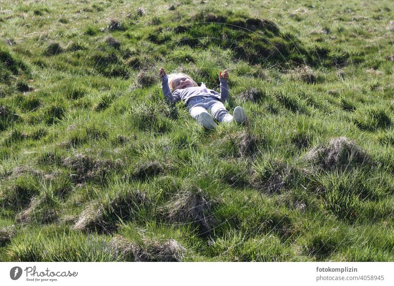Child lying on a green grassy meadow Meadow Grass Infancy Growth Joie de vivre (Vitality) Relaxation Experiencing nature Contentment Well-being Healthy