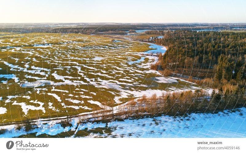 Season change. March rural landscape. Winter crops and plowed field panorama. snow spring nature aerial season background tree white forest green winter road