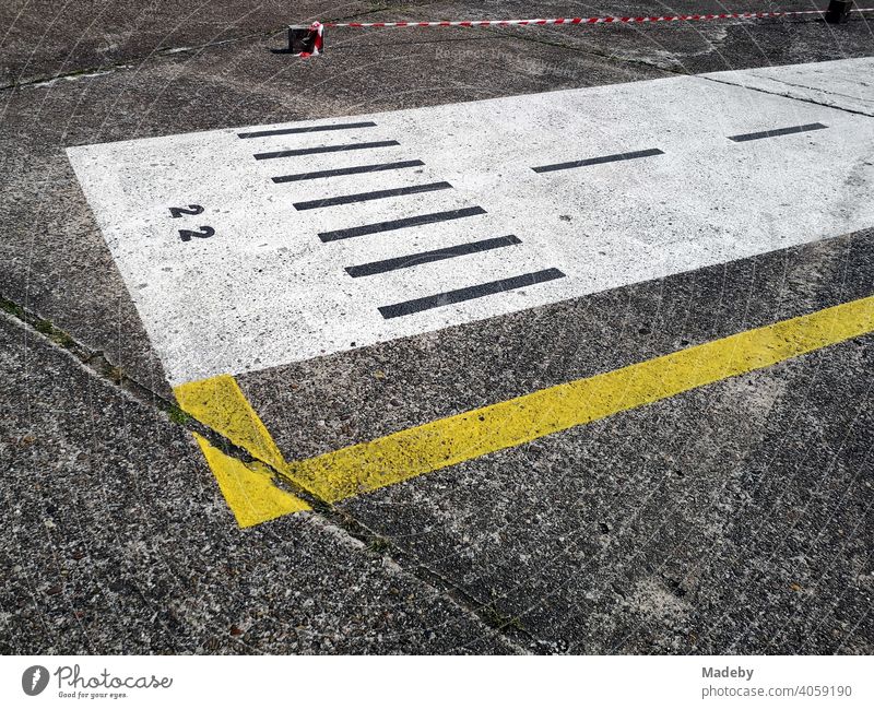 Painted runway on grey concrete at the airfield festival at the gliding airfield in Oerlinghausen near Bielefeld in the Teutoburg Forest in East Westphalia-Lippe