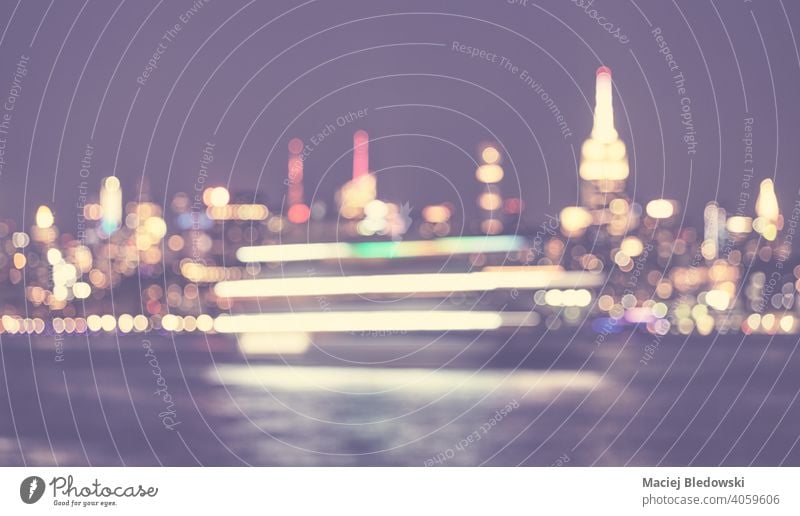 Defocused picture of New York City waterfront skyline at night, color toned urban abstract background, USA. city blurred bokeh defocused Manhattan light NYC