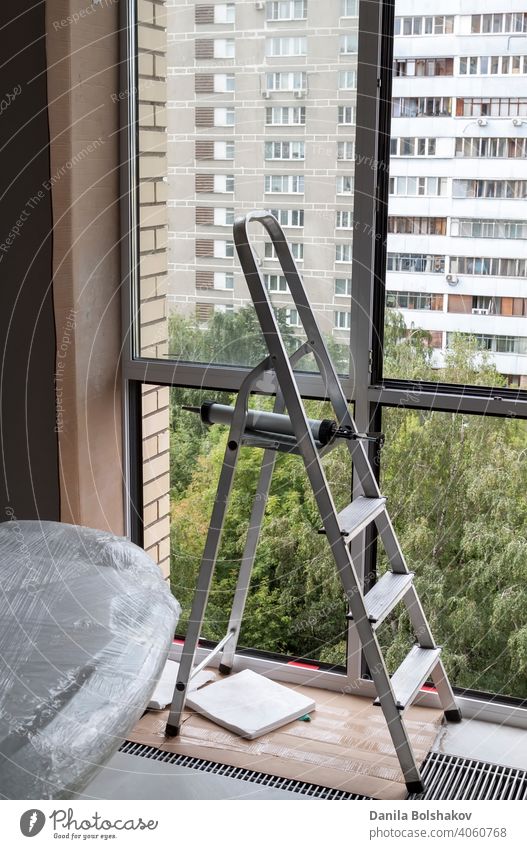 Stepladder near window with glass removed in apartment aluminium building comfortable construction element equipment estate floor frame home house indoor