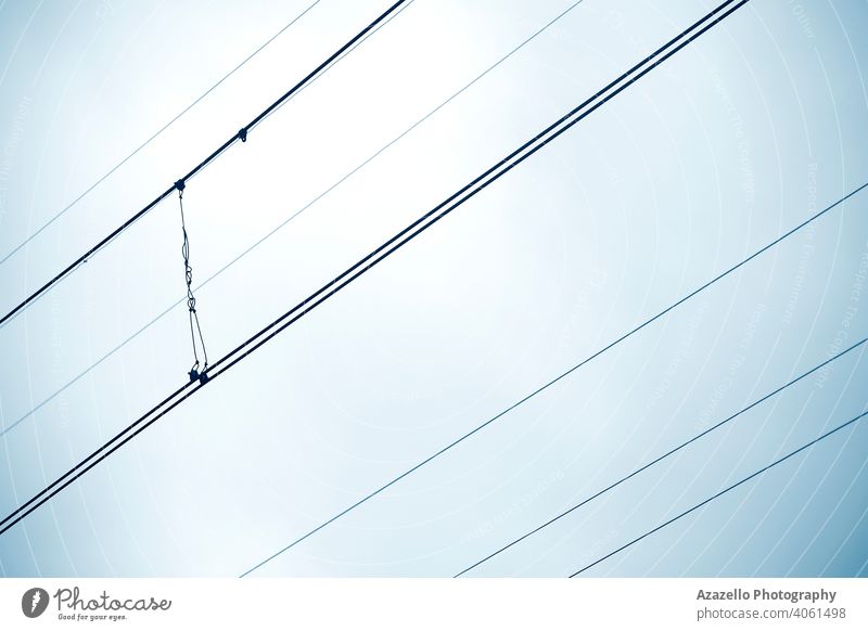 Traction wires view against the sky. Minimalist image of diagonal wires. abstract background black blue business cable current danger design electric electrical