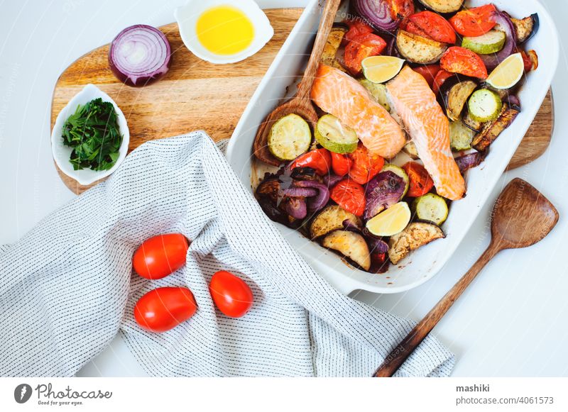 oven roasted vegetable mix  - tomato, red onion, zucchini and eggplant with baked salmon. Healthy diet vegetarian dinner or lunch food healthy meal cooking