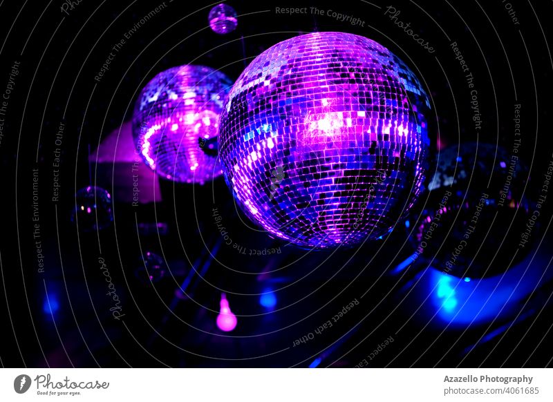 Disco ball in a night club in blue and purple lights. Mirror ball with reflections and beams. abstract backdrop background bright celebration colorful cool