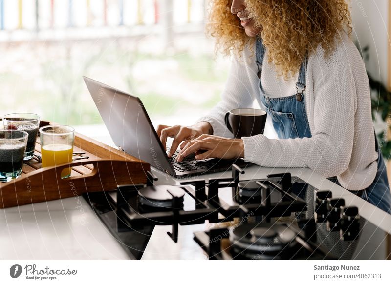 Unrecognizable woman using laptop in kitchen. middle age couple love cooking home cozy caucasian relationship preparing female happy person stove alone
