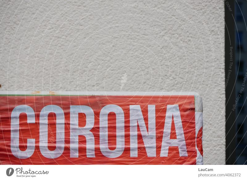 White lettering "Corona" on red background in front of light house wall corona Virus coronavirus Corona Pandemic coronavirus SARS-CoV-2 corona crisis writing