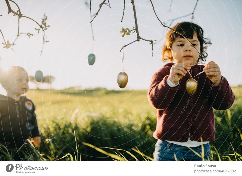 Brother and sister playing with Easter eggs outdoors Brothers and sisters Family & Relations Child 2 1 - 3 years Caucasian Spring Together Happiness Joy Day