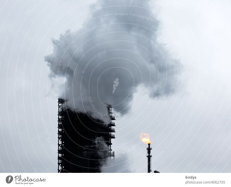 Extinguishing tower of the steelworks Thyssen-Krupp coking plant in Duisburg. enormous steam cloud, extinguishing cloud which arises during the cooling of hot coke in a wooden tower, the extinguishing tower.