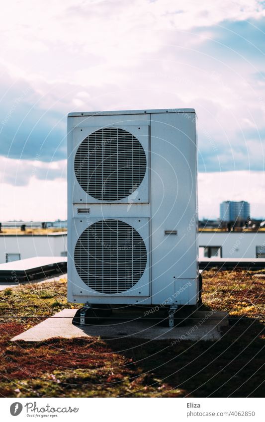 Air source heat pump on the roof of a residential house. Modern and environmentally friendly heating technology. Heating Roof Sustainability Apartment Building