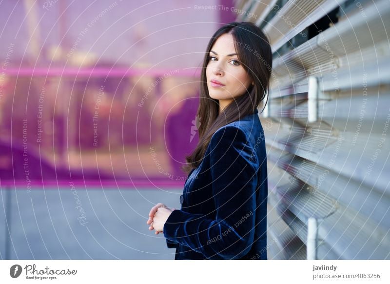 Woman wearing blue suit posing near a modern building. woman girl pink person fashion model lifestyle female urban background lady one elegant blind outside