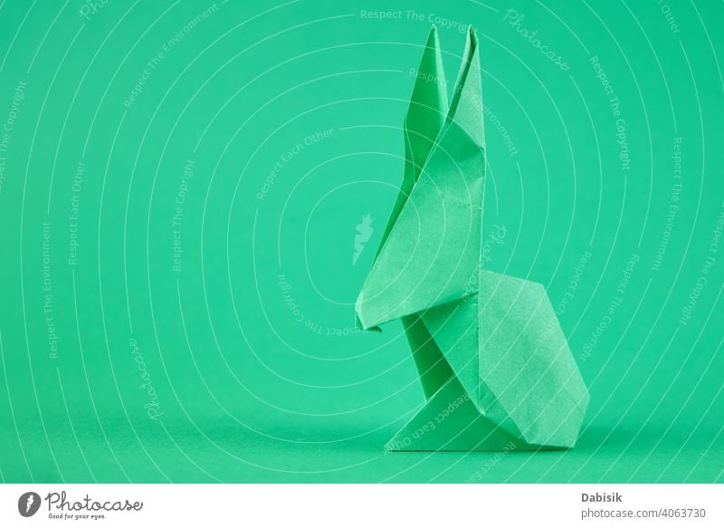 Paper origami Esater rabbit on a green background. Easter celebration concept easter bunny holiday animal decoration spring happy paper cute art colorful