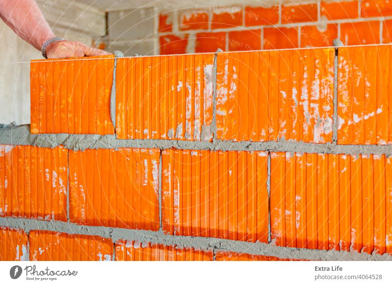 Worker is building wall with red blocks and mortar Accuracy Accurate Activity Architecture Block Brick Bricklayer Bricklaying Brickwork Builder Building Site