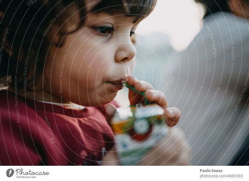 Child drinking juice from straw 1 - 3 years Caucasian Girl Authentic Straw Juice Drinking Colour photo Infancy Human being Exterior shot Toddler Joy Lifestyle