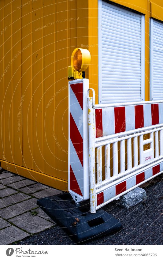 red-white barrier in front of container cordon Construction site Container shutters Striped Orange Red Protection Safety Exterior shot Bans barrier tape