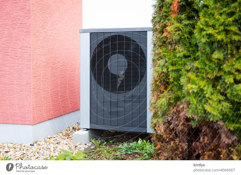 Air source heat pump in the front garden of a house. Modern, environmentally friendly heating technology. Air source heat pump Heating Air-to-water heat pump