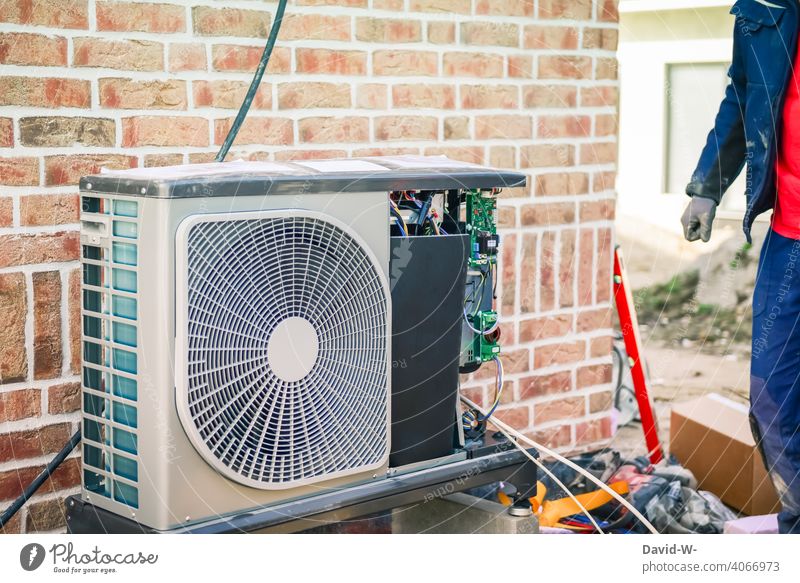 Installation of an air source heat pump by an installer Air source heat pump installation Installer Renewable energy Modern Innovative New building