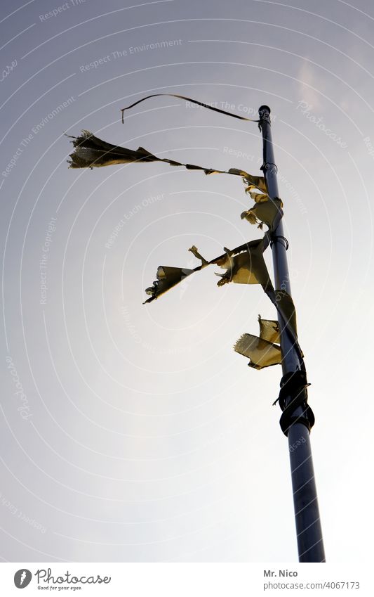 windswept flagpole Sky Cloudless sky Beautiful weather Scrap Scrap of fabric Blow Wind windy Sun Flagpole Judder remnants Broken Worn out Abrasion Gale Rip