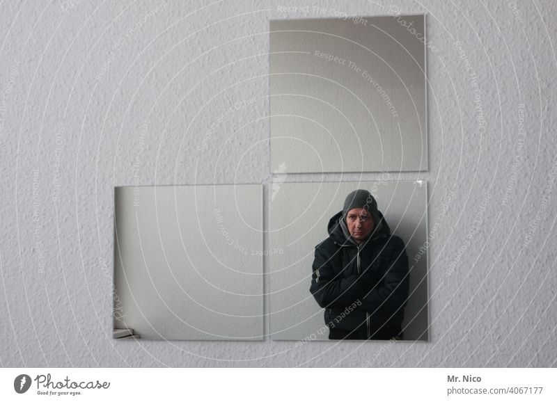mirror image Mirror Mirror image Man Reflection Self portrait Upper body Looking Wall (building) Gray Cold Jacket Cap Interior shot crossed arms Exceptional
